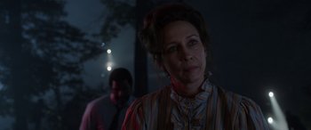 Movie still from “The Conjuring: The Devil Made Me Do It” (2021), directed by Michael Chaves – A woman in a striped shirt standing in front of a man; Close Up shot, Over the shoulder angle