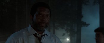 Movie still from “The Conjuring: The Devil Made Me Do It” (2021), directed by Michael Chaves – A man wearing a white dress shirt and a tie; Close Up shot, Low angle