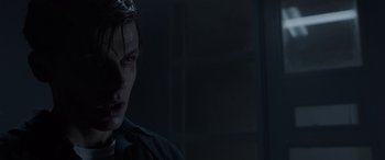 Movie still from “The Conjuring: The Devil Made Me Do It” (2021), directed by Michael Chaves – A young man with dark hair is looking at the camera; Close Up shot, Over the shoulder angle