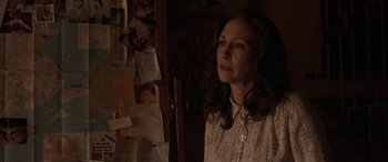 Movie still from “The Conjuring: The Devil Made Me Do It” (2021), directed by Michael Chaves – A woman standing in front of a bunch of papers on a wall; Close Up shot, Over the shoulder angle