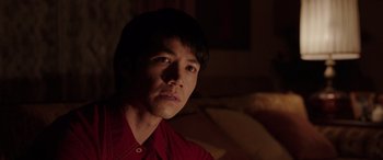 Movie still from “The Conjuring: The Devil Made Me Do It” (2021), directed by Michael Chaves – A man in a red shirt is looking at the camera; Close Up shot, Over the shoulder angle