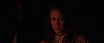 Movie still from “The Conjuring: The Devil Made Me Do It” (2021), directed by Michael Chaves – A woman in a white shirt is in the dark; Close Up shot, Over the shoulder angle