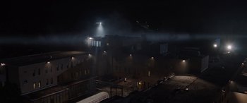 Movie still from “The Conjuring: The Devil Made Me Do It” (2021), directed by Michael Chaves – A train is on the tracks in the dark; Extreme Wide shot, High angle