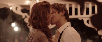 Movie still from “The Conjuring: The Devil Made Me Do It” (2021), directed by Michael Chaves – A man and a woman kissing each other in front of a building; Close Up shot, Low angle