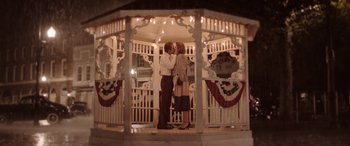 Movie still from “The Conjuring: The Devil Made Me Do It” (2021), directed by Michael Chaves – A man and a woman kissing in a gazebo; Wide shot, Low angle