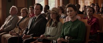 Movie still from “The Conjuring: The Devil Made Me Do It” (2021), directed by Michael Chaves – A group of people sitting next to each other in a room; Medium shot, Over the shoulder angle