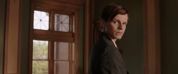 Movie still from “The Conjuring: The Devil Made Me Do It” (2021), directed by Michael Chaves – A man in a suit standing in front of a window; Close Up shot, Low angle