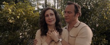 Movie still from “The Conjuring: The Devil Made Me Do It” (2021), directed by Michael Chaves – A man and a woman standing next to each other in front of trees; Close Up shot, Over the shoulder angle
