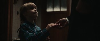 Movie still from “The Courier” (2020), directed by Dominic Cooke – A man holding a woman's hand while they both look at each other; Close Up shot, Over the shoulder angle