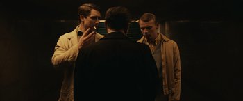 Movie still from “The Courier” (2020), directed by Dominic Cooke – A group of men standing next to each other in front of a mirror; Medium shot, Low angle