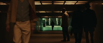 Movie still from “The Courier” (2020), directed by Dominic Cooke – A man is standing in a subway tunnel; Extreme Wide shot, Low angle