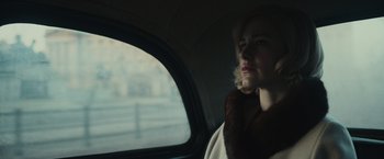 Movie still from “The Courier” (2020), directed by Dominic Cooke – A woman sitting in the back of a car looking out the window; Close Up shot, Low angle
