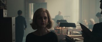 Movie still from “The Courier” (2020), directed by Dominic Cooke – A woman in a black shirt is in front of a piano; Close Up shot, Over the shoulder angle