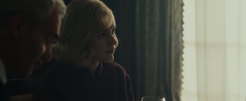 Movie still from “The Courier” (2020), directed by Dominic Cooke – A woman sitting at a table with a glass of wine; Close Up shot, Over the shoulder angle