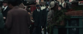 Movie still from “The Courier” (2020), directed by Dominic Cooke – A group of men walking down a street; Medium shot, Over the shoulder angle