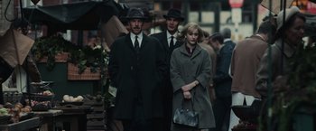 Movie still from “The Courier” (2020), directed by Dominic Cooke – A man and two women are walking down the street; Medium shot, High angle