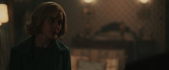 Movie still from “The Courier” (2020), directed by Dominic Cooke – A woman with blonde hair and a green jacket; Close Up shot, Over the shoulder angle