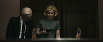 Movie still from “The Courier” (2020), directed by Dominic Cooke – A woman is holding a coffee mug in her hand; Medium shot, Over the shoulder angle