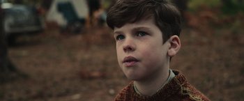 Movie still from “The Courier” (2020), directed by Dominic Cooke – A young boy is looking into the distance; Close Up shot, Over the shoulder angle