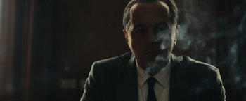 Movie still from “The Courier” (2020), directed by Dominic Cooke – A person wearing a suit and tie; Close Up shot, Low angle