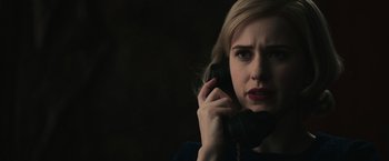 Movie still from “The Courier” (2020), directed by Dominic Cooke – A woman is talking on a phone in a dimly - lit room; Close Up shot, Low angle