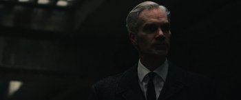 Movie still from “The Courier” (2020), directed by Dominic Cooke – A person wearing a suit and tie; Close Up shot, Low angle
