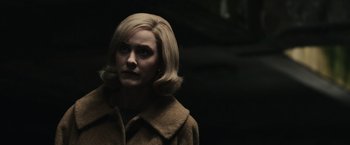 Movie still from “The Courier” (2020), directed by Dominic Cooke – A woman with blonde hair wearing a brown coat; Close Up shot, Over the shoulder angle