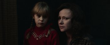 Movie still from “The Courier” (2020), directed by Dominic Cooke – A woman and a girl are looking at the camera; Close Up shot, High angle