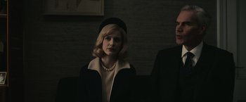 Movie still from “The Courier” (2020), directed by Dominic Cooke – A woman wearing a black hat and a black coat; Medium shot, Low angle