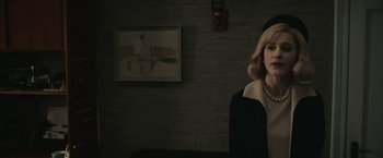 Movie still from “The Courier” (2020), directed by Dominic Cooke – A woman wearing a black hat and a black coat; Medium shot, Over the shoulder angle