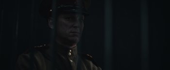 Movie still from “The Courier” (2020), directed by Dominic Cooke – A man in a uniform is looking at the camera; Close Up shot, Low angle