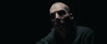 Movie still from “The Courier” (2020), directed by Dominic Cooke – A man with a bald head is looking at the camera; Close Up shot, High angle