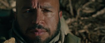 Movie still from “The Covenant” (2023), directed by Guy Ritchie – A man with a beard and mustache; Close Up shot, Low angle