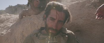 Movie still from “The Covenant” (2023), directed by Guy Ritchie – A person with a beard; Close Up shot, Over the shoulder angle