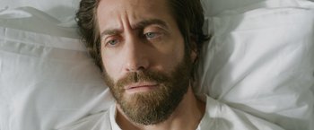 Movie still from “The Covenant” (2023), directed by Guy Ritchie – A person with a beard; Close Up shot, High angle