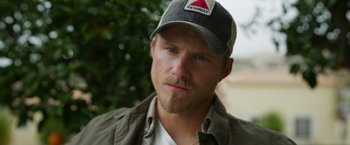 Movie still from “The Covenant” (2023), directed by Guy Ritchie – A person wearing a hat; Close Up shot, Low angle