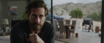 Movie still from “The Covenant” (2023), directed by Guy Ritchie – A person sitting in front of a window; Close Up shot, Over the shoulder angle