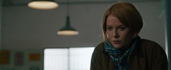 Movie still from “The Covenant” (2023), directed by Guy Ritchie – A woman with red hair wearing a brown jacket; Close Up shot, Low angle