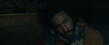 Movie still from “The Covenant” (2023), directed by Guy Ritchie – A person with a beard; Close Up shot, Over the shoulder angle