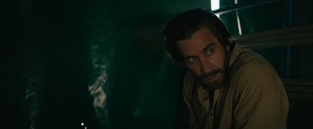 Movie still from “The Covenant” (2023), directed by Guy Ritchie – A man with a goatee and a beard; Close Up shot, Over the shoulder angle