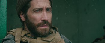 Movie still from “The Covenant” (2023), directed by Guy Ritchie – A person with a beard; Close Up shot, Over the shoulder angle