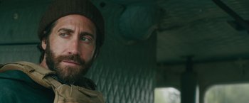 Movie still from “The Covenant” (2023), directed by Guy Ritchie – A person with a beard wearing a hat; Close Up shot, Over the shoulder angle