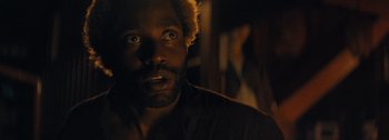 Movie still from “The Creator” (2023), directed by Gareth Edwards – A person with his eyes wide open; Close Up shot, Over the shoulder angle
