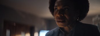 Movie still from “The Creator” (2023), directed by Gareth Edwards – A person looking at the camera; Close Up shot, Over the shoulder angle