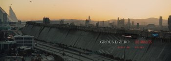 Movie still from “The Creator” (2023), directed by Gareth Edwards – A view of a city from a bridge at sunset; Extreme Wide shot, High angle