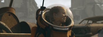 Movie still from “The Creator” (2023), directed by Gareth Edwards – A woman wearing a space suit and a helmet; Close Up shot, Low angle