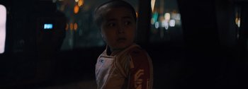 Movie still from “The Creator” (2023), directed by Gareth Edwards – A young boy is standing in the dark; Close Up shot, Low angle