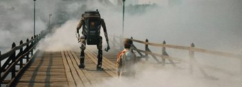 Movie still from “The Creator” (2023), directed by Gareth Edwards – A man and a robot walking on a bridge; Wide shot, Low angle
