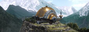 Movie still from “The Creator” (2023), directed by Gareth Edwards – An image of a building in the middle of a mountainous area; Extreme Wide shot, Low angle