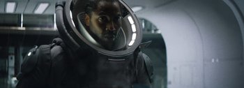 Movie still from “The Creator” (2023), directed by Gareth Edwards – A man in a spacesuit looking into a mirror; Close Up shot, Low angle